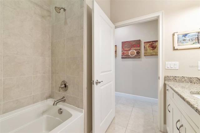 bathroom with tile patterned flooring, vanity, and tiled shower / bath