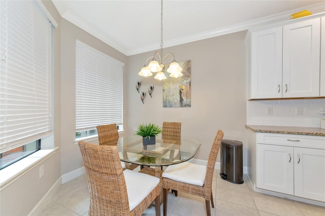 dining room featuring ornamental molding, light tile patterned floors, and a chandelier