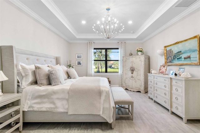 bedroom featuring a tray ceiling, a chandelier, and ornamental molding