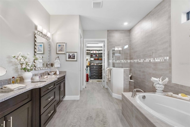 bathroom with plus walk in shower and vanity