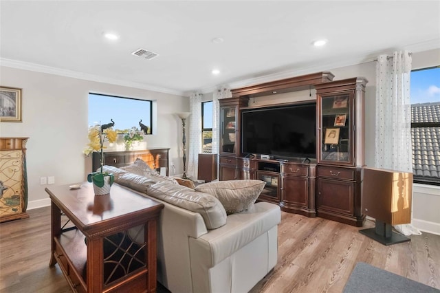 living room with ornamental molding and light wood-type flooring