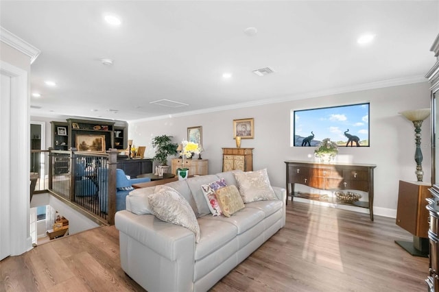 living room with light hardwood / wood-style floors and ornamental molding