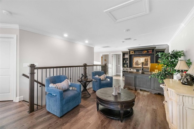 sitting room with hardwood / wood-style floors and ornamental molding