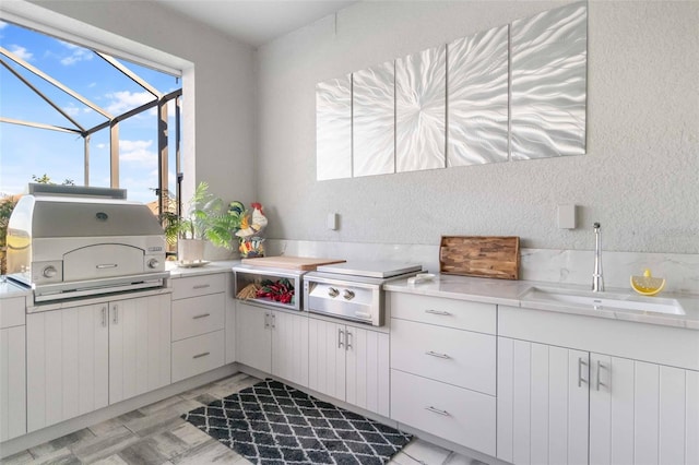 kitchen featuring sink and white cabinets