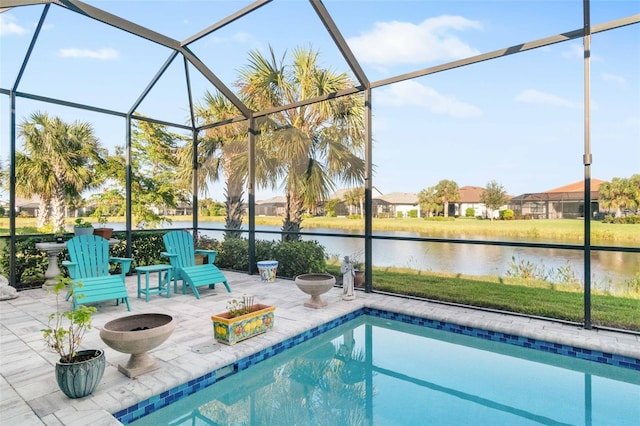 view of pool with a patio, a water view, and a lanai