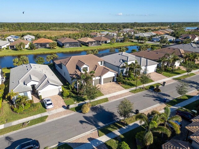 drone / aerial view with a residential view and a water view