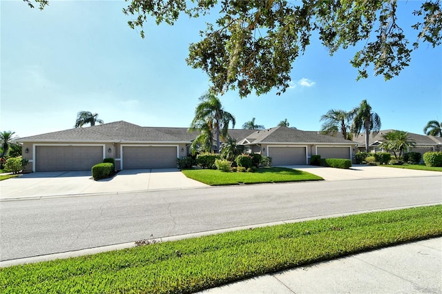 ranch-style home with a front yard and a garage