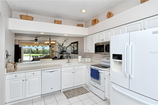 kitchen with white appliances, white cabinets, sink, ceiling fan, and light tile patterned floors