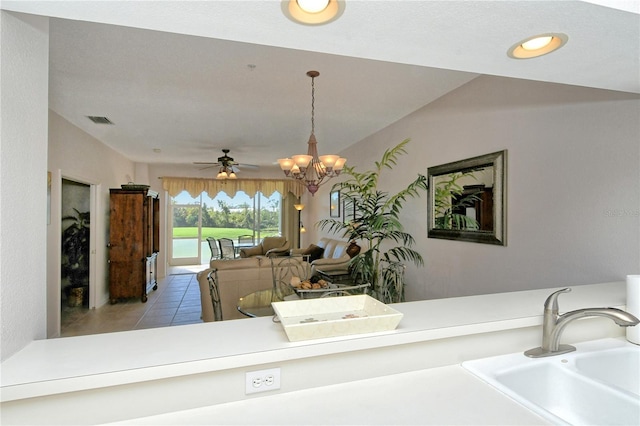 interior space with ceiling fan with notable chandelier and sink