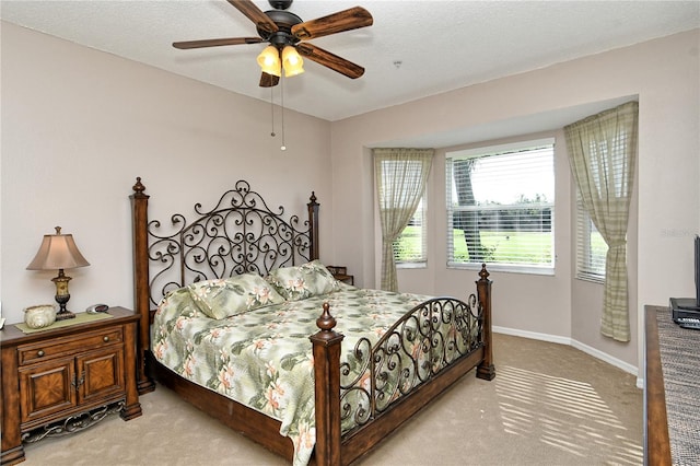 carpeted bedroom featuring a textured ceiling and ceiling fan