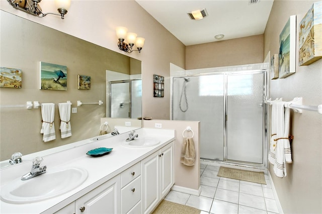 bathroom featuring vanity, tile patterned floors, and a shower with shower door