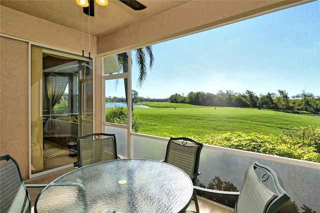 sunroom / solarium featuring ceiling fan