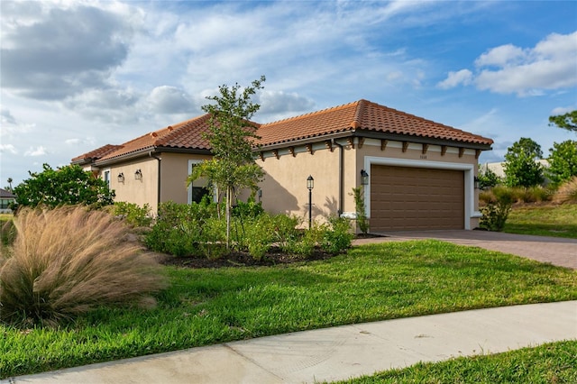 view of front facade with a garage and a front lawn