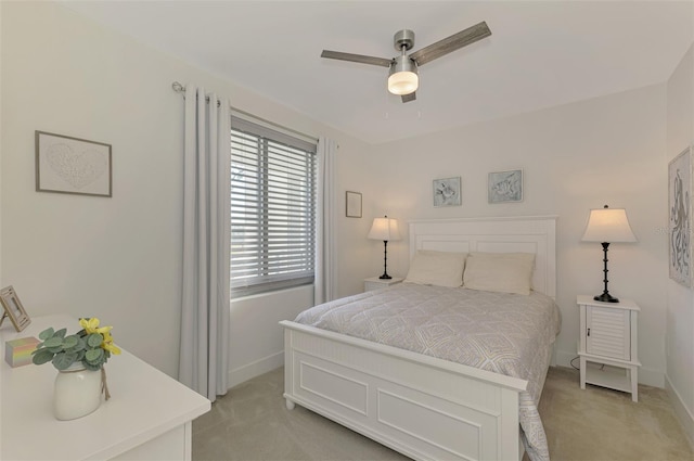 bedroom featuring ceiling fan and light carpet