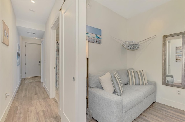 corridor with light hardwood / wood-style floors