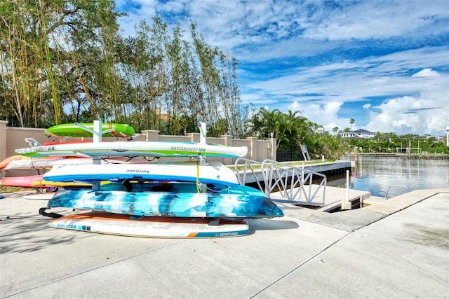 view of swimming pool featuring a water view and a boat dock