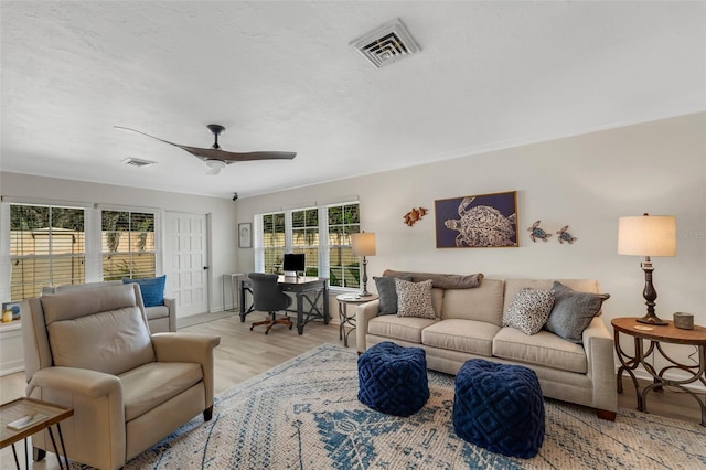 living room with ceiling fan and light hardwood / wood-style flooring