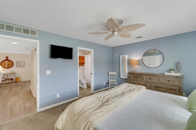 bedroom featuring ensuite bath, ceiling fan, and light hardwood / wood-style floors