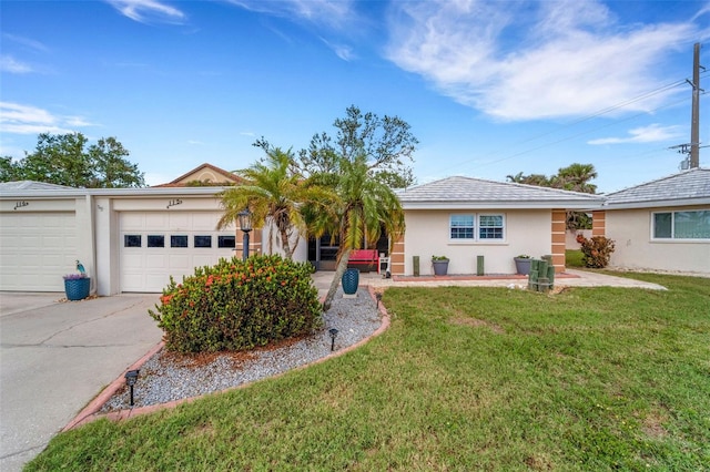 ranch-style house featuring a front lawn and a garage