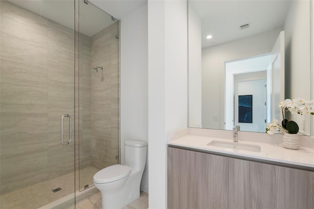 bathroom with tile patterned flooring, vanity, toilet, and a shower with door