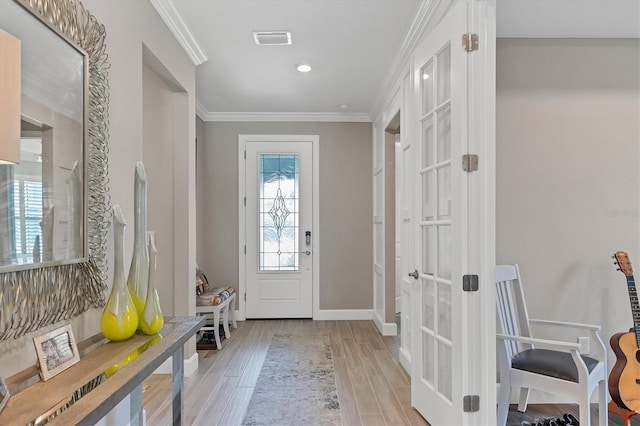 mudroom featuring crown molding, french doors, and light wood-type flooring