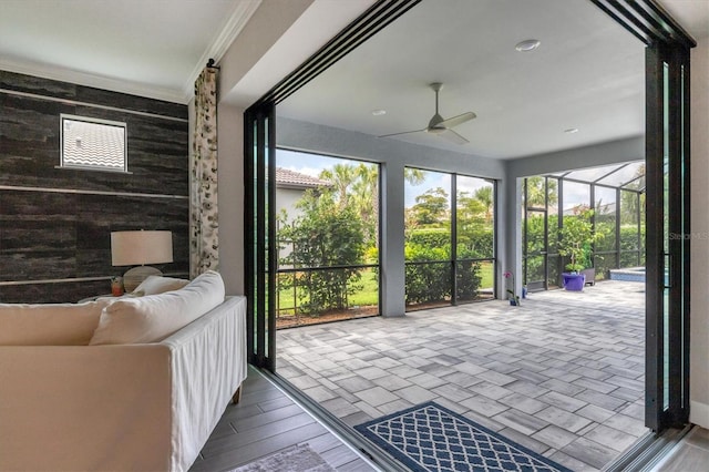 sunroom featuring ceiling fan