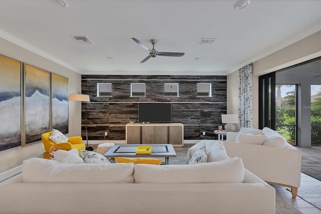 living room featuring ceiling fan and ornamental molding