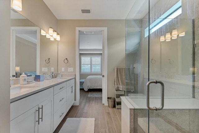 bathroom featuring vanity, wood-type flooring, and an enclosed shower