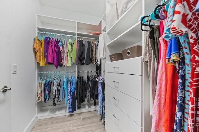 spacious closet with light hardwood / wood-style floors