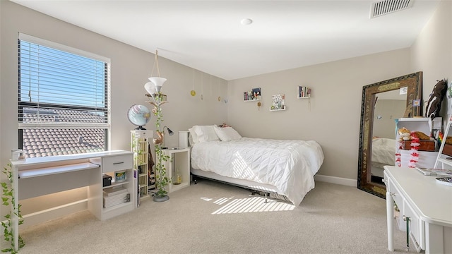 bedroom featuring light carpet