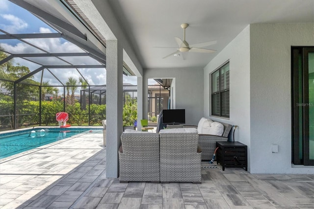 view of patio with an outdoor living space, ceiling fan, and a lanai