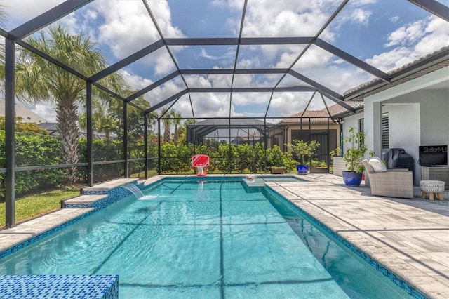 view of pool featuring a lanai, pool water feature, and a patio