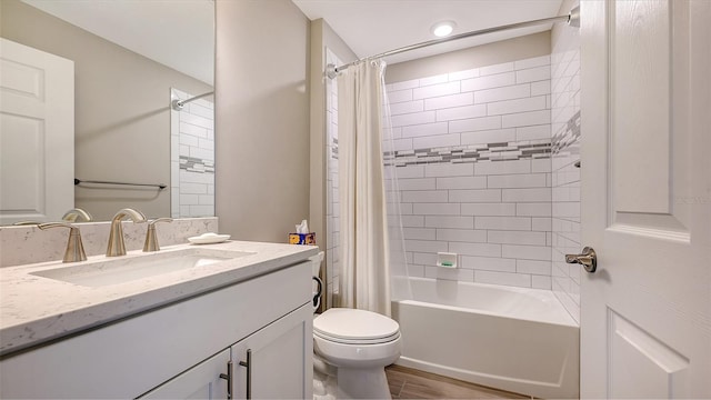 full bathroom with hardwood / wood-style floors, vanity, shower / bath combo, and toilet