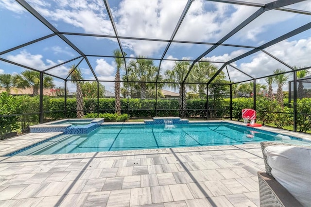 view of swimming pool with an in ground hot tub, a patio, and glass enclosure