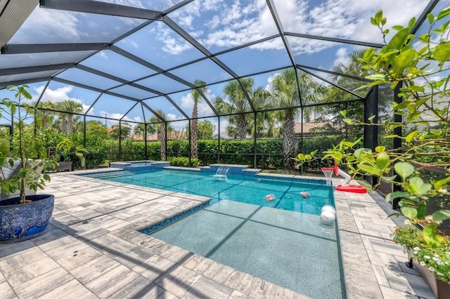 view of swimming pool with pool water feature, a patio area, a lanai, and an in ground hot tub