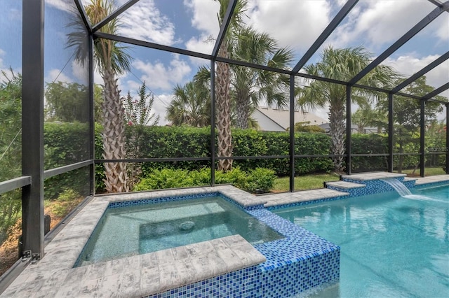 view of swimming pool featuring pool water feature, a lanai, and an in ground hot tub