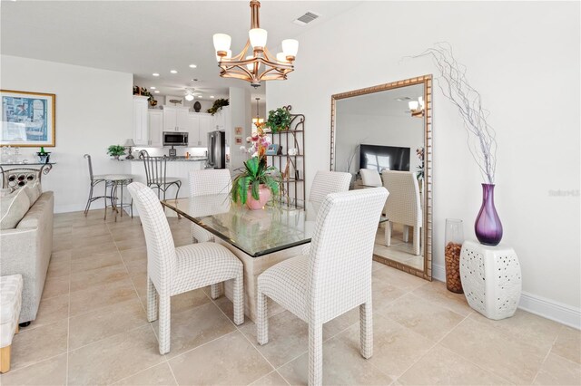 dining room with light tile patterned floors and a notable chandelier