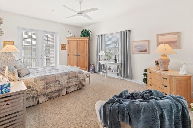 bedroom with access to exterior, ceiling fan, and light colored carpet