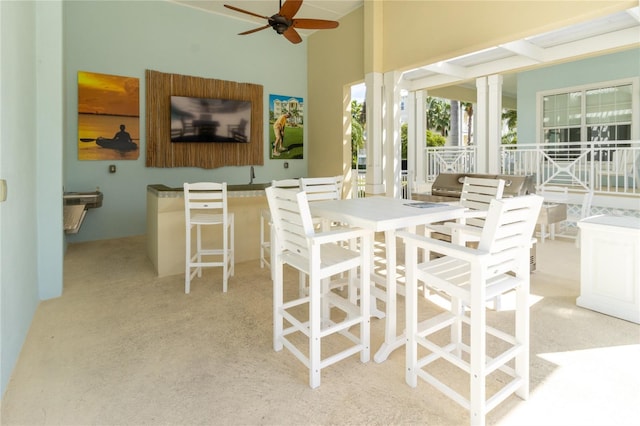 view of patio / terrace featuring ceiling fan and a bar