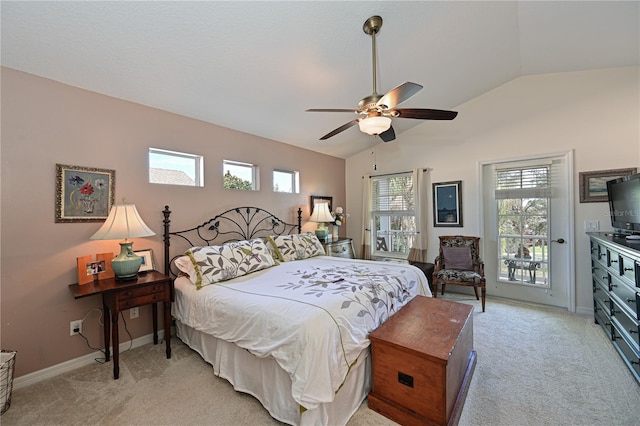 bedroom featuring ceiling fan, vaulted ceiling, light colored carpet, and multiple windows