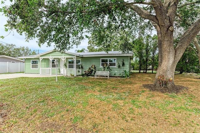 view of front of home with covered porch and a front yard