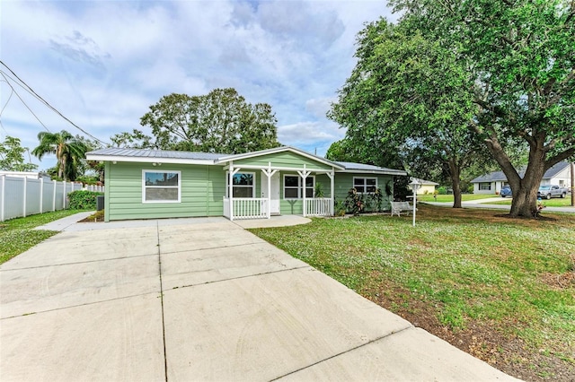 ranch-style home with a front yard and a porch