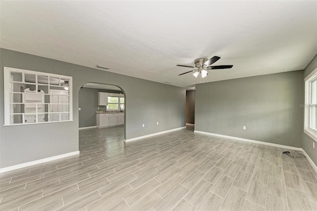 spare room featuring ceiling fan and light hardwood / wood-style flooring