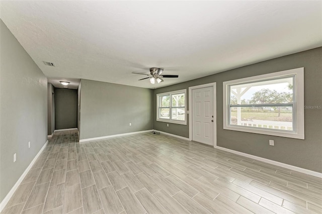 unfurnished living room with ceiling fan and light wood-type flooring