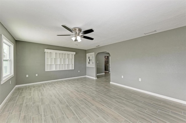 spare room featuring light wood-type flooring and ceiling fan