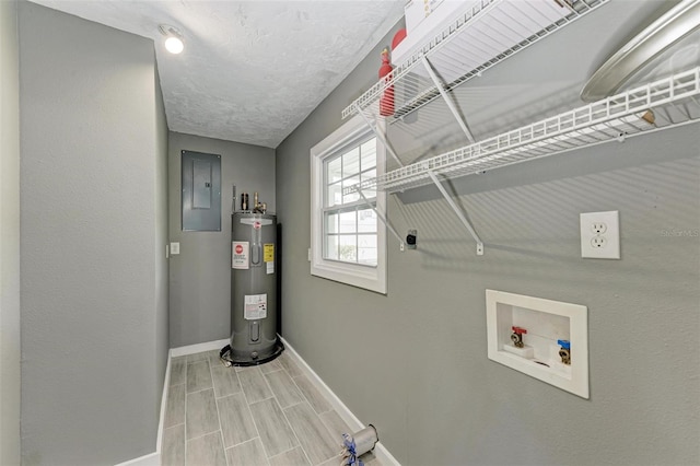 washroom with hookup for an electric dryer, hookup for a washing machine, electric water heater, wood-type flooring, and electric panel