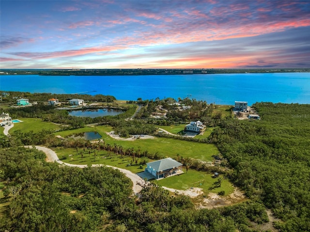 aerial view at dusk with a water view