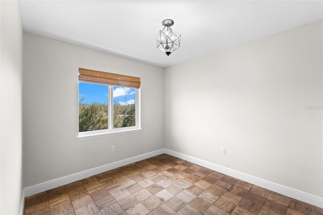 445 Horseshoe Loop Rd, Terra Ceia, FL 34250 - empty room with baseboards and a chandelier