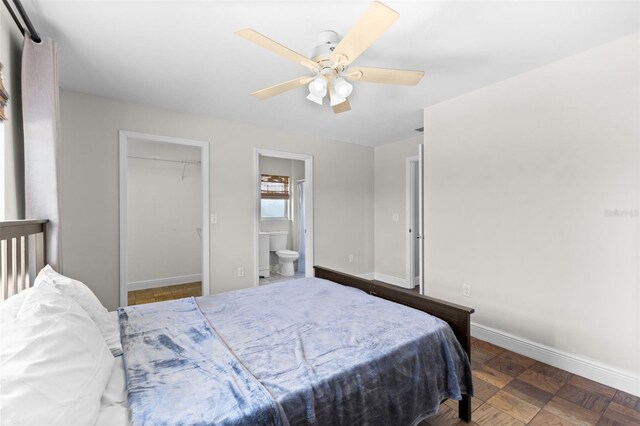 445 Horseshoe Loop Rd, Terra Ceia, FL 34250 - bedroom featuring baseboards, a walk in closet, a ceiling fan, and ensuite bath