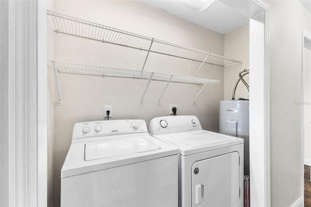 clothes washing area featuring washer and dryer and electric water heater